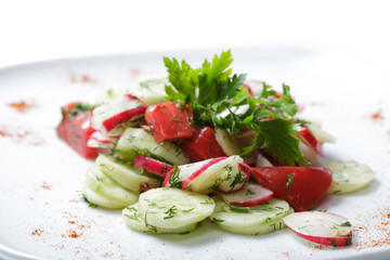 vegetables salad on  white plate. tomatoes and cucumber