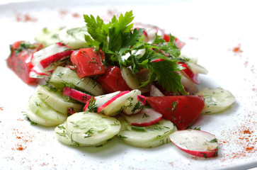 vegetables salad on  white plate. tomatoes and cucumber