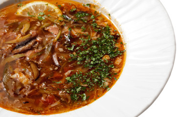 tasty soup in a white plate on a white background