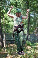 Portrait of  boy wearing helmet and climbing. Child in a adventu