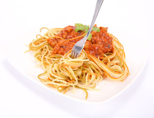 Colorful spaghetti bolognese being eaten with a fork