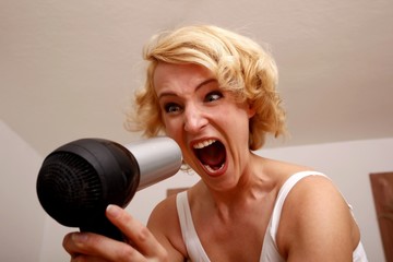crying sporty beauty with hair drier