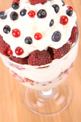 Whipped cream with raspberries, red currants and blue berries