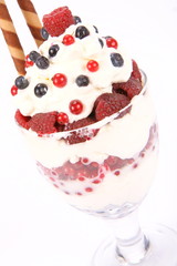 Whipped cream with raspberries, red currants and blue berries
