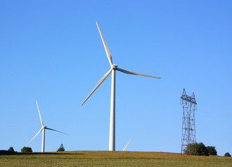 Wind Turbine and Electricity Pylon in the Evening