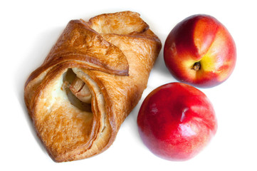 croissant and red peaches isolation on white
