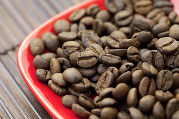saucer and coffee beans on a bamboo mat