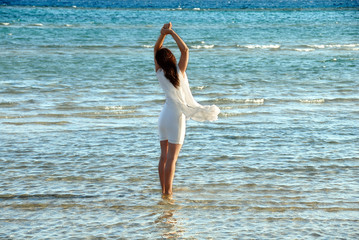Woman in white dress in sea