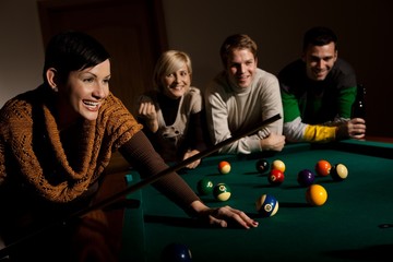 Woman laughing at snooker table