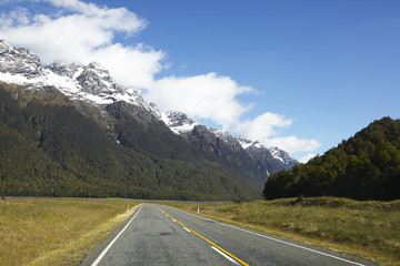 Road in the national park surrounded with mountains and forest