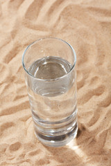 glass of water on the sand