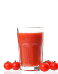 Fresh tomatoes and a glass full of tomato juice