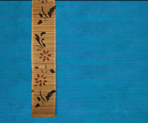 Flower bamboo banner on blue ribbed wood background