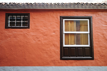 old wooden windows of orange facade