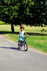 Fototapeta premium little girl rides a bike