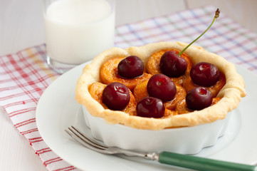 Apricot tart with cherries and milk