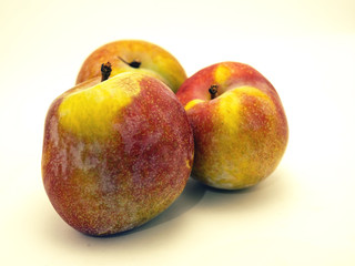 Fresh peaches on white background