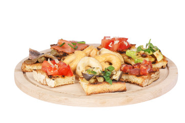 Italian bruschetta and taralli over a wooden cutting board