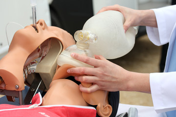The man on a dummy trains to do Cardiopulmonary resuscitation