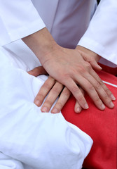 The man on a dummy trains to do Cardiopulmonary resuscitation