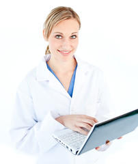 Charming female doctor holding a laptop looking at the camera