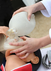 The man on a dummy trains to do Cardiopulmonary resuscitation