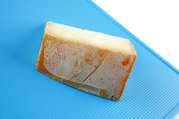 light gauda cheese on blue