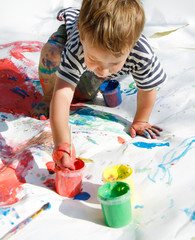 boy painting over white