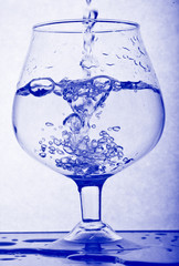 Water poured into glass. Frozen motion.