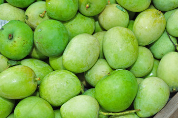 green mangoes in the markets