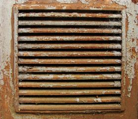 little square rusty  metal ventilation shaft exit with peeling p