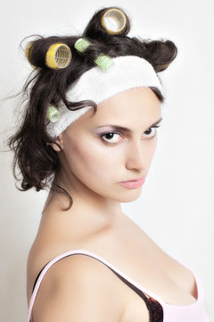Portrait of housewife with curlers in her hair