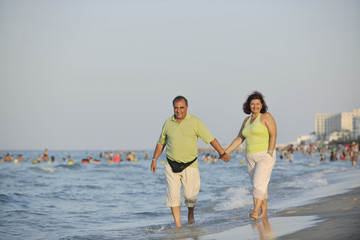 happy seniors couple  on beach