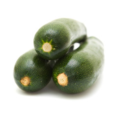 three stacked zucchini ( courgette) isolated on white background