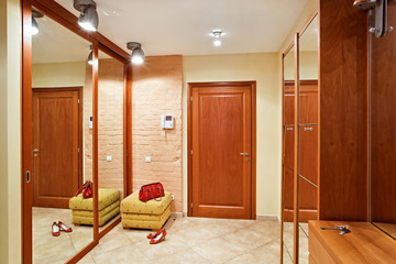 Elegance anteroom interior in warm tones with hallstand and mirr