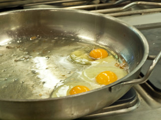 Three eggs frying