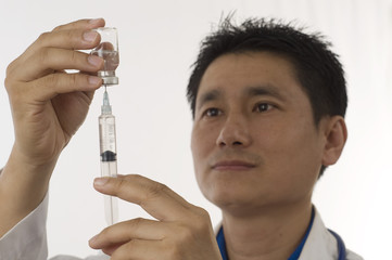 Doctor filling syringe