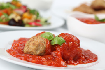 Roast meatballs with tomato sauce. Shallow DOF