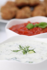 Tzatziki and tomato sauce. Shallow DOF