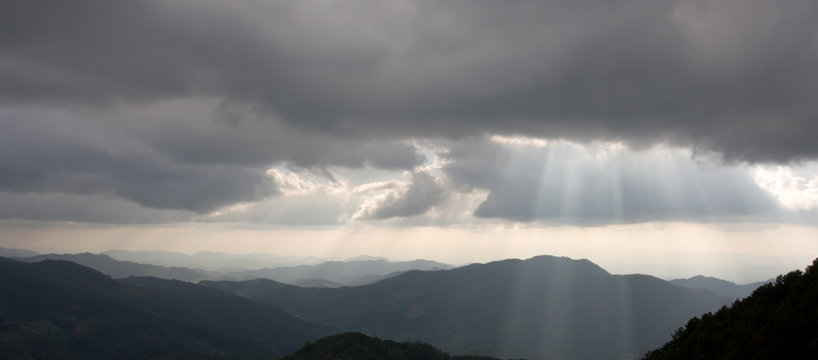 Fototapeta Mountains silhouette and sun rays
