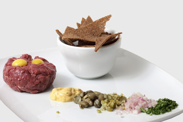 Meat and crackers on a plate. isolated on a white background
