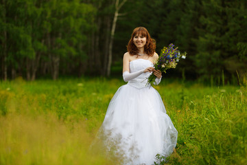 Fototapeta na wymiar The girl in a wedding dress