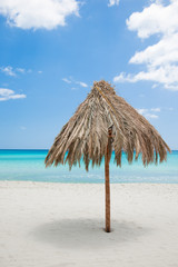 Fototapeta na wymiar sun umbrella of reeds on the beach