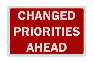 Photo realistic 'changed priorities ahead' sign, isolated on pur