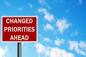 Photo realistic 'changed priorities ahead' sign, with space for