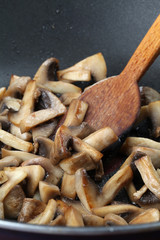 Fried mushrooms in a wok. Shallow dof
