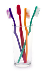 colourful toothbrushes in a glass