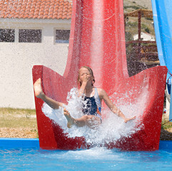 Girl splashing into a pool