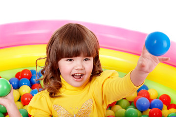 Fototapeta na wymiar Little girl play in group colourful ball.