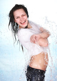 Girl in water splashing. Body care.